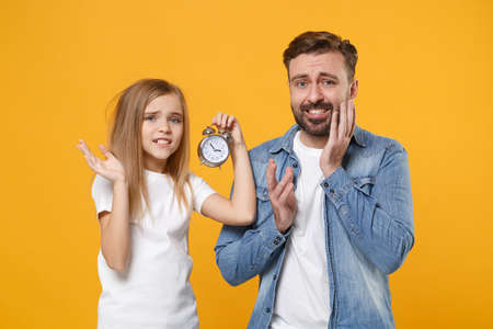 Concerned bearded man in casual clothes with child baby girl. Father little kid daughter isolated on...