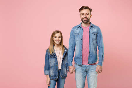 Smiling bearded man in casual clothes have fun with cute child baby girl. Father little kid daughter isolated on pastel pink wall background.の写真素材