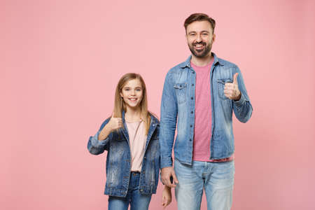 Smiling bearded man in casual clothes with child baby girl. Father little kid daughter isolated on pastel pink background studio portrait.の写真素材