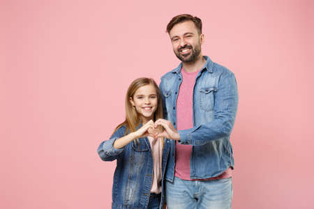 Smiling bearded man in casual clothes with child baby girl. Father little kid daughter isolated on pastel pink background.の写真素材