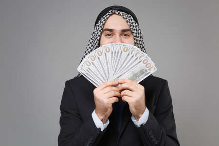 Funny arabian muslim businessman in keffiyeh kafiya ring igal agal classic black suit isolated on...
