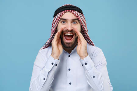 Arabian muslim man in keffiyeh kafiya ring igal agal casual clothes isolated on pastel blue...