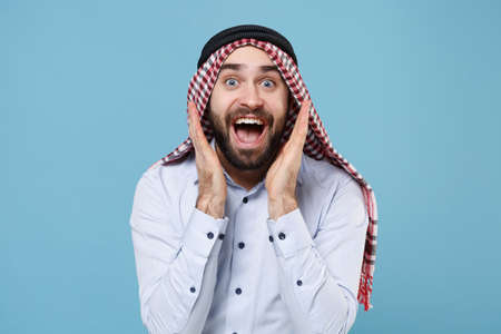 Surprised young bearded arabian muslim man in keffiyeh kafiya ring igal agal casual clothes isolated...