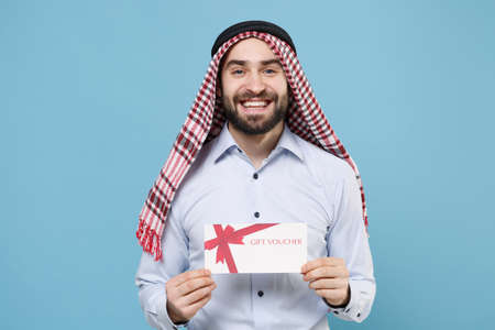 Smiling young bearded arabian muslim man in keffiyeh kafiya ring igal agal casual clothes posing...