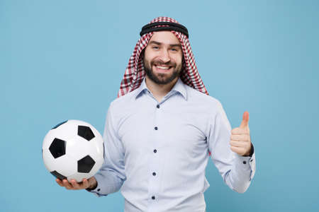 Funny arabian muslim man in keffiyeh kafiya ring igal agal casual clothes isolated on pastel blue background.の写真素材