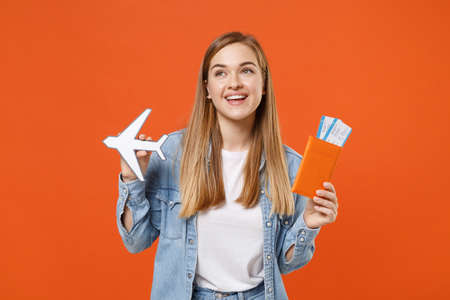 Cheerful young woman girl in casual denim clothes posing isolated on orange background studio portrait.の写真素材