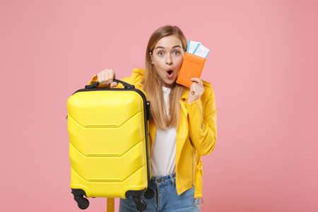 Shocked young woman girl in yellow leather jacket posing isolated on pastel pink background studio portrait.の写真素材