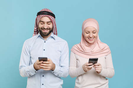 Smiling couple friends arabian muslim man wonam in keffiyeh kafiya ring igal agal hijab clothes...
