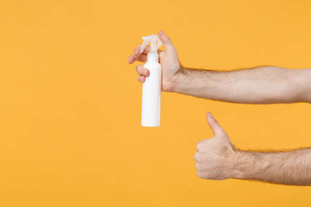 Close up cropped photo of male hold in hand bottle with alcohol liquid antibacterial sanitizer...
