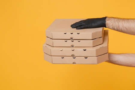 Close up male hands black glove hold in hand stack pizza in clear empty blank cardboard brown...