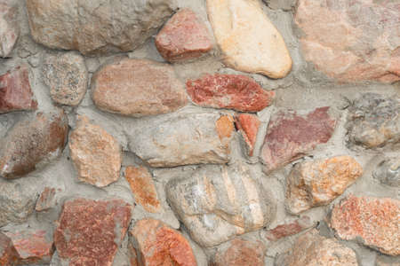 Masonry made of natural granite boulder close-up