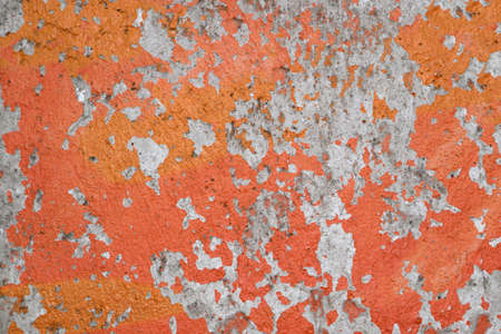 Shabby orange paint from concrete walls, orange-gray textureの写真素材