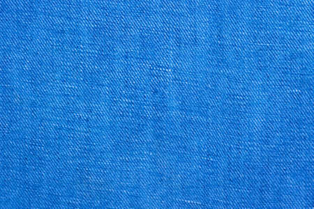 Blue denim background. Cotton jeans cloth texture