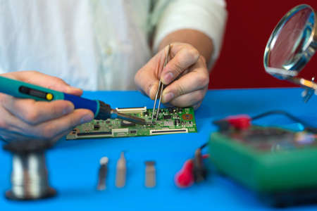 Repair of the video converter board of the TV signal. Soldering of electronic components by an...