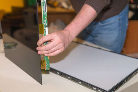 Replacing the screen in a modern LCD TV with LED backlight in the service center.