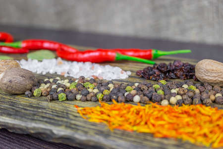 Oriental spices on the cutting Board, bright and spicy pepper, saffron and nutmegの写真素材