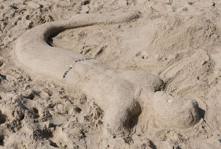 Sand sculpture of a merman.