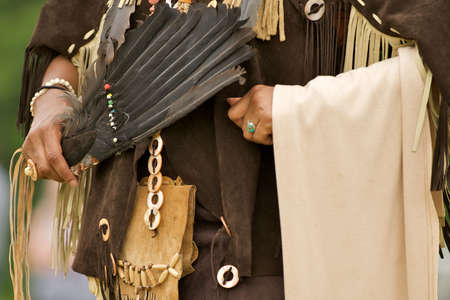 Native American regalia of leather and feathers.