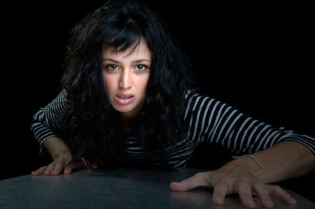 Beautiful brunette fashion model on black background.の写真素材