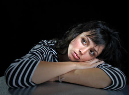 Beautiful brunette fashion model on black background.の写真素材