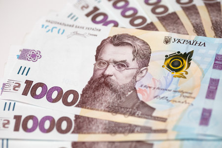 One thousand hryvnia bills circle heap on white background.