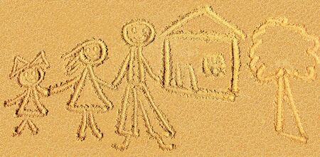 childish sand drawing of the family on the beachの写真素材