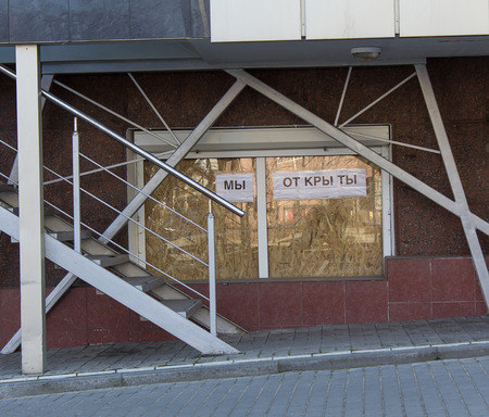 Donetsk, Ukraine - March, 25, 2015: Showcase in the city center. Closed plywood and the inscription \"We are open\"のeditorial素材
