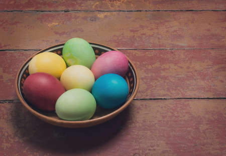 Multi-colored Easter eggs in a bowl. Retroの写真素材