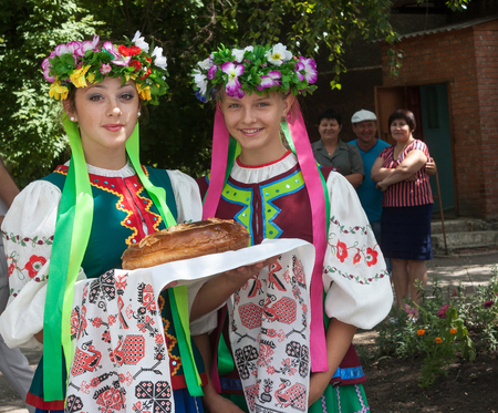 Donetsk, Ukraine - 26 July, 2013: Girls in national costumes prepare to welcome miners Donetsk Coal Energy Company with extracted 1000 000 tonnes of coal this yearのeditorial素材