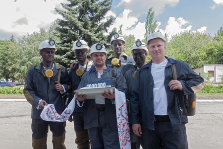 Donetsk, Ukraine - 26 July, 2013: Miners with coal symbolic ingot at the ceremony in honor of 1000000 tons of coal mined in Donetsk coal and energy company in the current yearのeditorial素材
