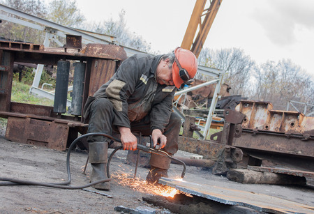 Donetsk, Ukraine - November, 06, 2012: Man working cutting torch on the mine yard. The mine named after Skochinskiyのeditorial素材
