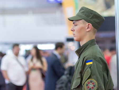 Kiev, Ukraine - September 22, 2015: Young soldier from the National Guard has been serving at the specialized exhibition "Arms and Security - 2015"のeditorial素材