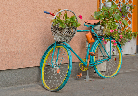 Old bicycle with flowers and a basket by the wall. Decorの写真素材