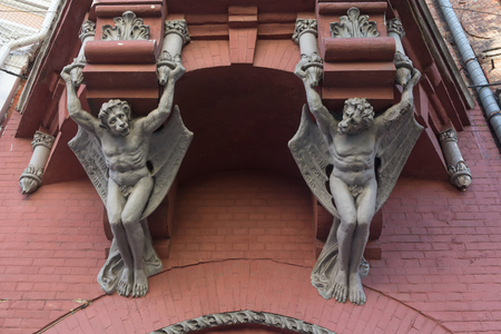 Sculptures demon with wings on wall of house in Kiev. Ukraineの写真素材