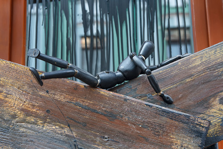 Figurine wooden man lying on the boards. Decorationの写真素材