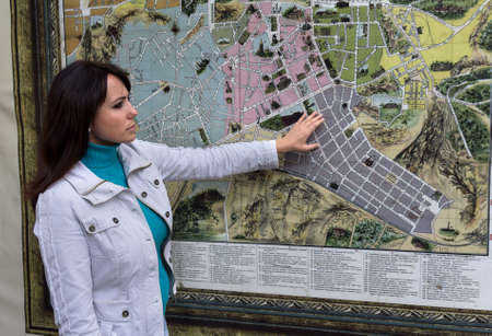 Woman contemplates the city map on the wall. Peopleのeditorial素材