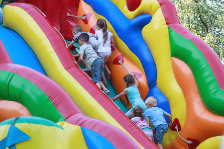 Kiev, Ukraine - August 30, 2015: Children climbing on the inflatable slidesのeditorial素材