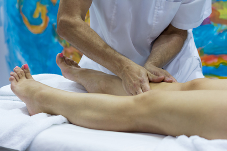 Hands of the masseur and the client's feet during a massage treatment. Medicineの写真素材