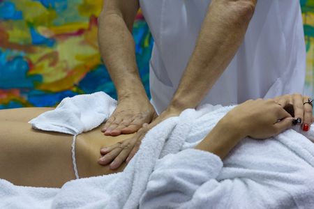 Hands of the masseur and the client's body during massage treatment. Medicineの写真素材
