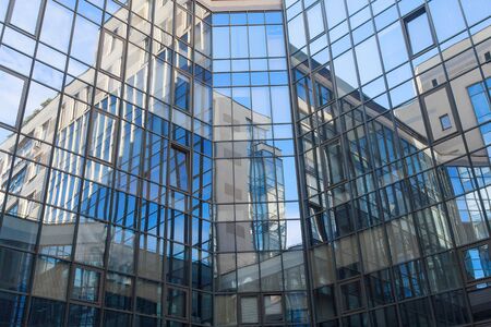 Reflection in a square glass-fronted faÃ§ade. Architectural abstraction