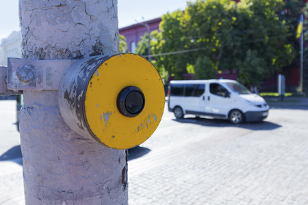 Yellow signal button for the blind at the junction of the road