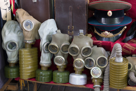 Kiev, Ukraine - June 04, 2016: Gas masks and a Soviet military uniform on the flea market counter on Andreevsky Descentのeditorial素材