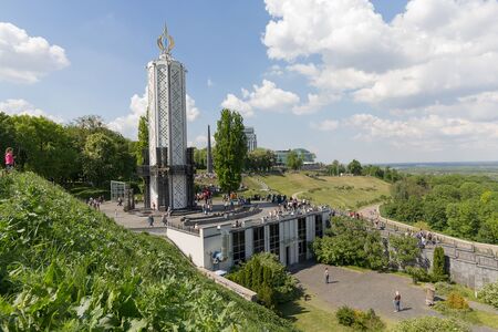 Kiev, Ukraine - May o9, 2016: Monument to victims of Holodomor and Domes of Kiev-Pechersk Lavra in Kiev on green hills of Pecherskのeditorial素材