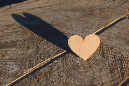Wooden heart on an old cracked surfaceの写真素材