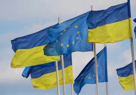 Flags of Ukraine and the European Union are developing against the background of the skyの写真素材