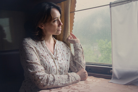Pensive girl at the train window. A train
