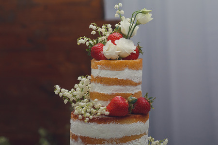 Wedding cake with meringue and strawberries closeup. Dessertの写真素材