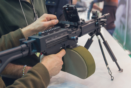 Machine gun in the hands of a man. Weapons