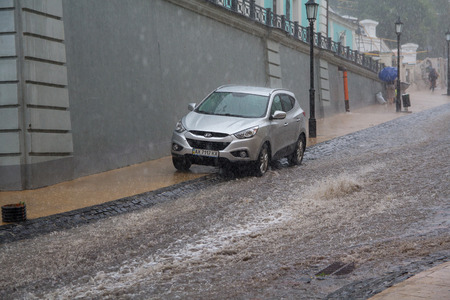 Kiev, Ukraine - July 01, 2017: Streams of water in heavy rain on Andreevsky Descent - the historical part of the cityのeditorial素材