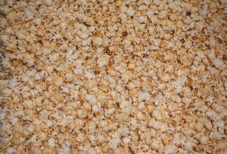 Golden popcorn grains close. Background and texturesの写真素材